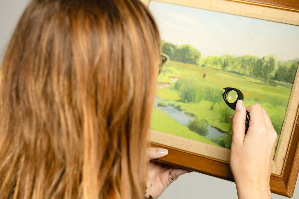 Examining fine art with loupe